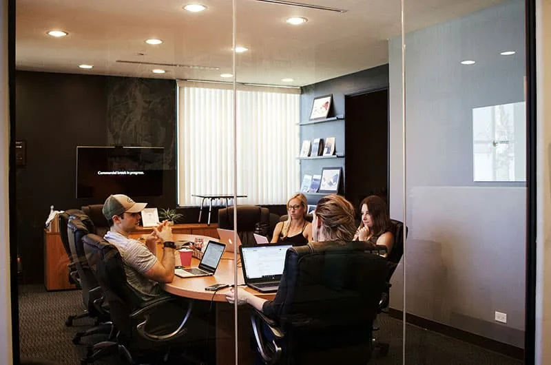 Consulting session in a glass-walled conference room